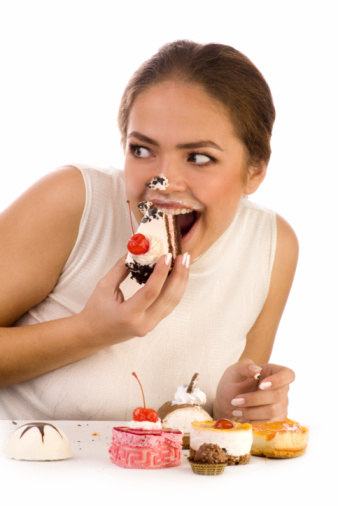 Young beautiful women eating cake